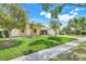 Charming single-story home with well-maintained lawn, mature trees, and welcoming curb appeal at 1604 Nottingham Dr, Winter Park, FL 32792