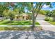 Charming single-story home with manicured lawn, mature trees, and a welcoming two-car garage at 1604 Nottingham Dr, Winter Park, FL 32792