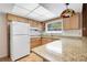 Well-lit kitchen with granite countertops, wood cabinets, and modern appliances at 1604 Nottingham Dr, Winter Park, FL 32792