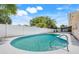 Swimming pool with ladder for ease of access, surrounded by a white fence for privacy at 1604 Nottingham Dr, Winter Park, FL 32792