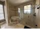 Luxurious bathroom featuring a walk-in shower and soaking tub at 1056 Castle Pines Ct, Reunion, FL 34747