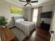 Bedroom features a serene atmosphere with a bed and golf course themed wall art at 1056 Castle Pines Ct, Reunion, FL 34747
