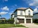 Beautiful two-story home with a well-maintained lawn and brick driveway, showcasing curb appeal at 1056 Castle Pines Ct, Reunion, FL 34747