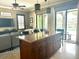 Spacious kitchen island with granite countertops and modern pendant lighting overlooking the open living space at 1056 Castle Pines Ct, Reunion, FL 34747