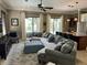 Spacious living room featuring a large sectional sofa, modern decor, and abundant natural light at 1056 Castle Pines Ct, Reunion, FL 34747