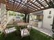 Inviting outdoor kitchen with pergola, stainless steel appliances, and ample seating for entertaining at 1056 Castle Pines Ct, Reunion, FL 34747