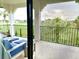 Relaxing patio with comfortable seating overlooking manicured lawns and lush trees at 1056 Castle Pines Ct, Reunion, FL 34747