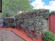 Backyard features a wood fence, privacy shrubs, and landscaping at 313 Morning Creek Cir, Apopka, FL 32712