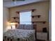 Comfortable bedroom featuring a ceiling fan, decorative shelving, and a queen-size bed at 313 Morning Creek Cir, Apopka, FL 32712
