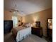 Comfortable bedroom features tile flooring, vaulted ceiling and neutral color palette at 313 Morning Creek Cir, Apopka, FL 32712