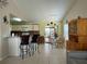Open-concept dining area features a glass table and convenient kitchen access at 313 Morning Creek Cir, Apopka, FL 32712