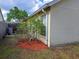 Exterior view of the house showing mulch landscaping by the wall at 313 Morning Creek Cir, Apopka, FL 32712