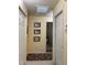 Bright hallway with decorative prints, tile floors, and access to multiple rooms at 313 Morning Creek Cir, Apopka, FL 32712