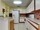 Spacious kitchen with white cabinets, tile backsplash, and efficient appliance arrangement at 313 Morning Creek Cir, Apopka, FL 32712