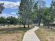 Park featuring a paved path, benches, and plenty of shade from the trees at 313 Morning Creek Cir, Apopka, FL 32712