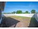 A serene backyard with a well-maintained lawn enclosed by a white privacy fence at 5616 Siltstone St, Lakeland, FL 33811