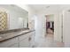 Well-lit bathroom features a granite countertop vanity and easy access to a walk-in closet at 5616 Siltstone St, Lakeland, FL 33811