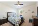 Comfortable bedroom with carpet flooring, bed with a blue and white flower pattern at 5616 Siltstone St, Lakeland, FL 33811