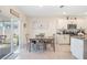 Open dining area with tile flooring, a modern light fixture, and access to the outdoor patio at 5616 Siltstone St, Lakeland, FL 33811