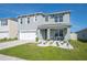 Inviting two-story home featuring a well-manicured lawn, tidy landscaping, and a welcoming front porch at 5616 Siltstone St, Lakeland, FL 33811