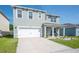 Attractive two-story home featuring an attached garage, tidy landscaping, and a welcoming front porch at 5616 Siltstone St, Lakeland, FL 33811