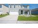 Charming two-story home featuring a well-manicured lawn and a two-car garage at 5616 Siltstone St, Lakeland, FL 33811