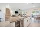 Stylish kitchen island with granite counters, seating, and a view into the living area at 5616 Siltstone St, Lakeland, FL 33811