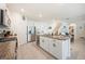 Spacious kitchen island with granite countertop, a built-in wine cooler, and barstool seating at 5616 Siltstone St, Lakeland, FL 33811