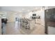 Open-concept kitchen with a large island, bar seating, granite counters, and stainless steel appliances at 5616 Siltstone St, Lakeland, FL 33811