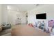 Bright living room features neutral tones, a large TV, and ample space for comfortable living at 5616 Siltstone St, Lakeland, FL 33811