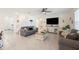 Open-concept living area with tile floors, comfortable seating, and easy access to the staircase at 5616 Siltstone St, Lakeland, FL 33811