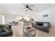 Open-concept living space with tile flooring connecting the kitchen, living, and dining areas at 5616 Siltstone St, Lakeland, FL 33811