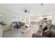Bright living area with neutral tones, a ceiling fan, and easy access to the kitchen and dining area at 5616 Siltstone St, Lakeland, FL 33811