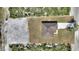 Overhead aerial view of new home featuring a neutral exterior, driveway, and surrounding undeveloped land at 2021 Valencia Dr, Indian Lake Estates, FL 33855