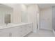 Modern bathroom with double sink vanity, quartz countertops and a separate shower area at 2021 Valencia Dr, Indian Lake Estates, FL 33855