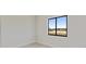 Bright, empty bedroom with a large window and neutral color scheme, perfect for customization at 2021 Valencia Dr, Indian Lake Estates, FL 33855