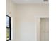 Simple bedroom with gray flooring and an exterior window offering natural light at 2021 Valencia Dr, Indian Lake Estates, FL 33855