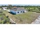 This is an exterior elevation view, which features a lawn in the front of the property at 2021 Valencia Dr, Indian Lake Estates, FL 33855