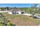 Charming single-story home featuring a well-manicured lawn, attached two-car garage and a neutral color palette at 2021 Valencia Dr, Indian Lake Estates, FL 33855