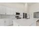 Bright kitchen with white cabinets, stainless steel appliances, and a center island with sink at 2021 Valencia Dr, Indian Lake Estates, FL 33855