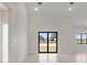 Bright and airy living room with large windows and access to outdoor spaces, perfect for entertaining at 2021 Valencia Dr, Indian Lake Estates, FL 33855