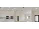 Bright open-concept living space featuring modern kitchen with stainless steel appliances and breakfast bar seating at 2021 Valencia Dr, Indian Lake Estates, FL 33855