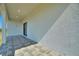 Covered patio area with tile flooring, adjacent to the house at 2021 Valencia Dr, Indian Lake Estates, FL 33855