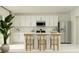 Bright, modern kitchen featuring white cabinetry, stainless steel appliances, and an island with bar seating at 2442 Mckinley Dr, Lake Wales, FL 33859