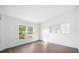 Sunlit bedroom with wood floors and an adjacent mirror at 3055 Steeplechase Dr, Lakeland, FL 33811
