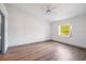 Bedroom featuring light-filled window and wood flooring at 3055 Steeplechase Dr, Lakeland, FL 33811