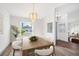 Elegant dining room featuring a wood table, upholstered chairs, and a modern chandelier at 3055 Steeplechase Dr, Lakeland, FL 33811
