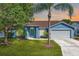 Charming single-story home boasts a well-manicured lawn, a symmetrical facade, and a two-car garage at 3055 Steeplechase Dr, Lakeland, FL 33811