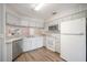 Well-lit kitchen with white appliances, ample cabinetry, and wood-look flooring at 3055 Steeplechase Dr, Lakeland, FL 33811
