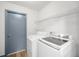 Convenient laundry room with shelving, washer, and dryer at 3055 Steeplechase Dr, Lakeland, FL 33811